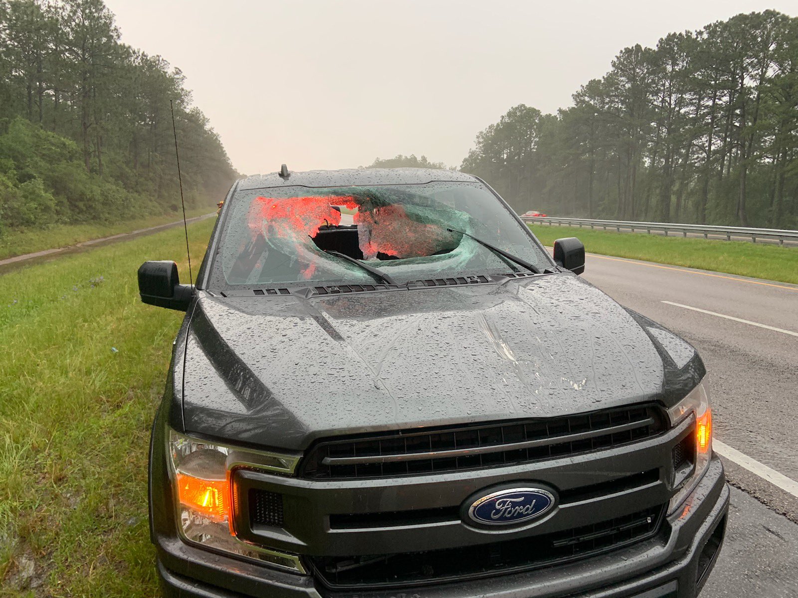 Lightning sends chunk of road through truck windscreen