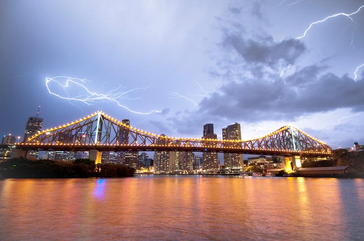 Image: Severe thunderstorms struck northeast NSW and southeast Qld. Source: Archive image of a thunderstorm over Brisbane City and Storey Bridge in the foreground. iStock: Credit:georgeclerk