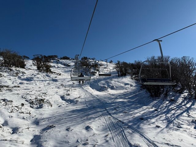 Image: Sunny skies midweek on the Leichhardt quad chairlift at Perisher, NSW. Source: Steve Smith