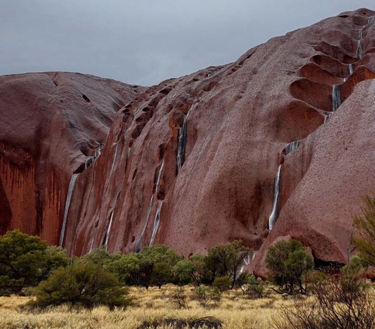 Waterfalls on Uluru after outback soaking, more rain to come